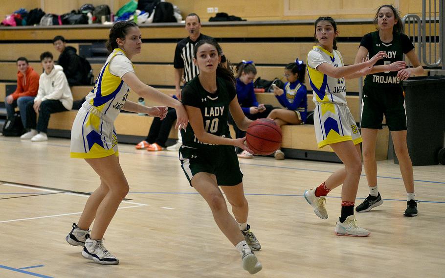 Ankara senior Jaia Kageorge drives to the basketball as Sigonella senior Anabel Vaiciulis defends during pool-play action of the DODEA European basketball championships on Feb.14, 2024, at the Wiesbaden Sports and Fitness Center on Clay Kaserne in Wiesbaden, Germany.