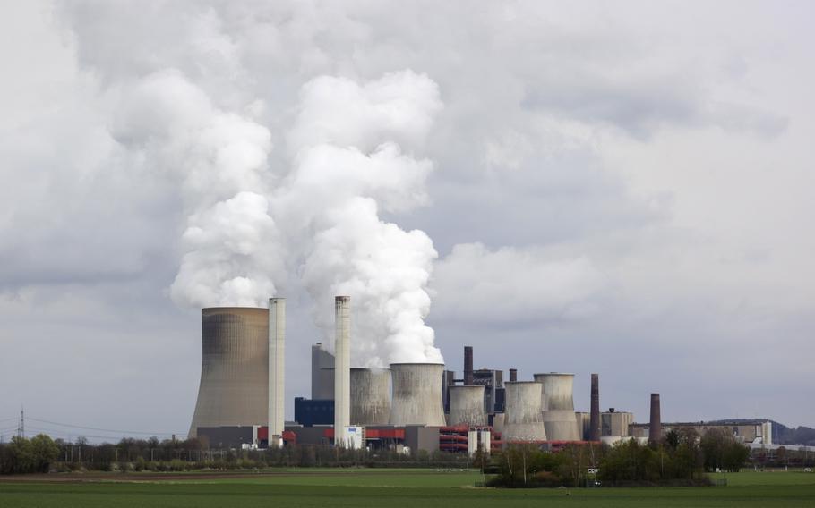 Cooling towers emit vapor at a lignite fueled power station in Bergheim Niederaussem, Germany.