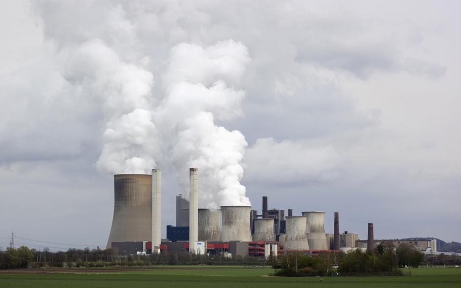 Cooling towers emit vapor at a lignite fueled power station in Bergheim Niederaussem, Germany.