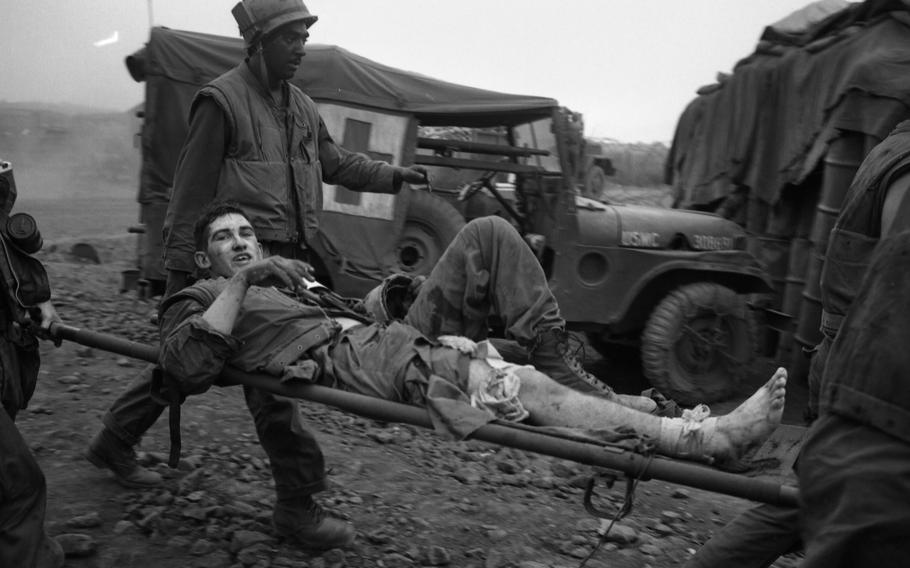 Marines carry wounded to helicopter pad 