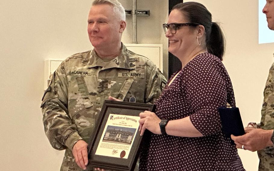 U.S. Forces Korea commander Gen. Paul LaCamera presents a principal of the year award to Mandy Schwerdt-Johnson of  Humphreys High School at Camp Humphreys, South Korea, Friday, May 19, 2023. 