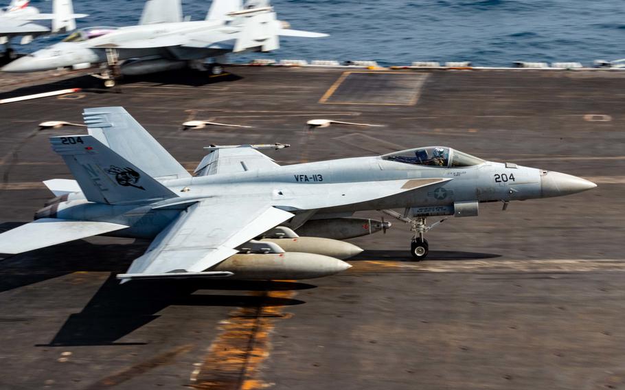 An F/A-18E Super Hornet recovers aboard the USS Carl Vinson during a dual-carrier exercise in the South China Sea, Sunday, Jan. 23, 2022. 