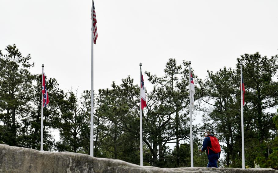 The four Confederate flags fly at the base of Stone Mountain’s popular walk-up trail on Tuesday, April 20, 2021.