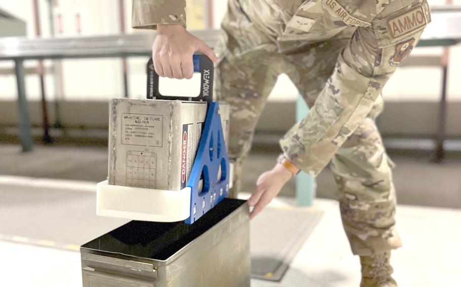 Airman 1st Class Donald Manunta-Lowell shows off the Hendy cradle prototype at Yokota Air Base, Japan, Sept. 16, 2022. 