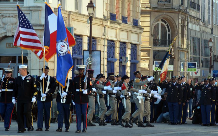The U.S. European Command Honor Guard and the French Honor Guard march as members of the 21st Theater Sustainment Command salute in Chalons-en-Champagne, France, Oct. 24, 2021. The soldiers were participating in ceremonies to remember the selection of the U.S. Unknown Soldier in this city 100 years ago.