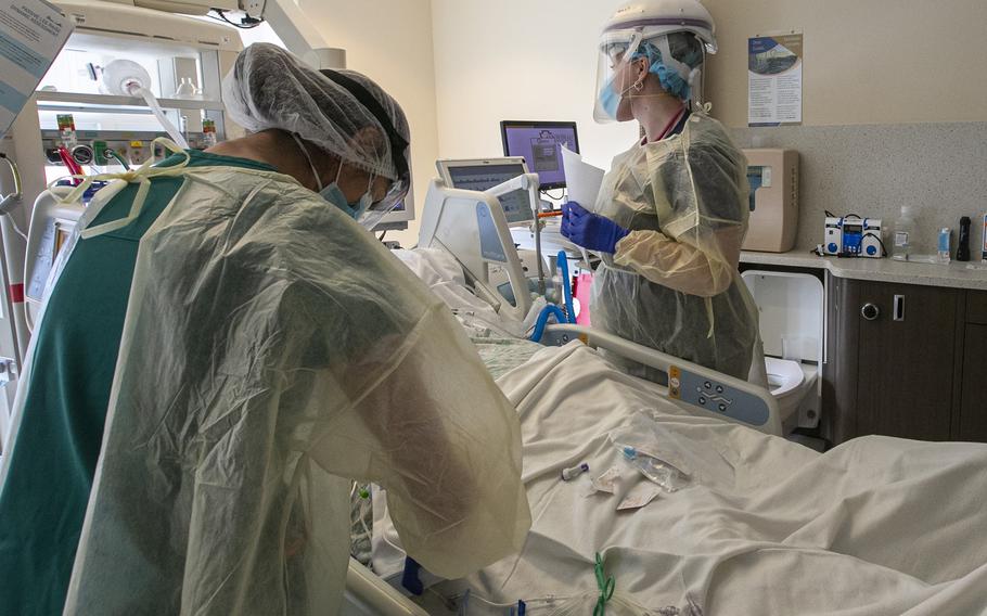 A nurse and respiratory therapist attend to a coronavirus patient in the Intensive Care Unit of Arrowhead Regional Medical Center on Dec. 23, 2020 in Colton, Calif. Nearly a year later, badly needed beds are being left open nationwide due to hospital staffing shortages. 