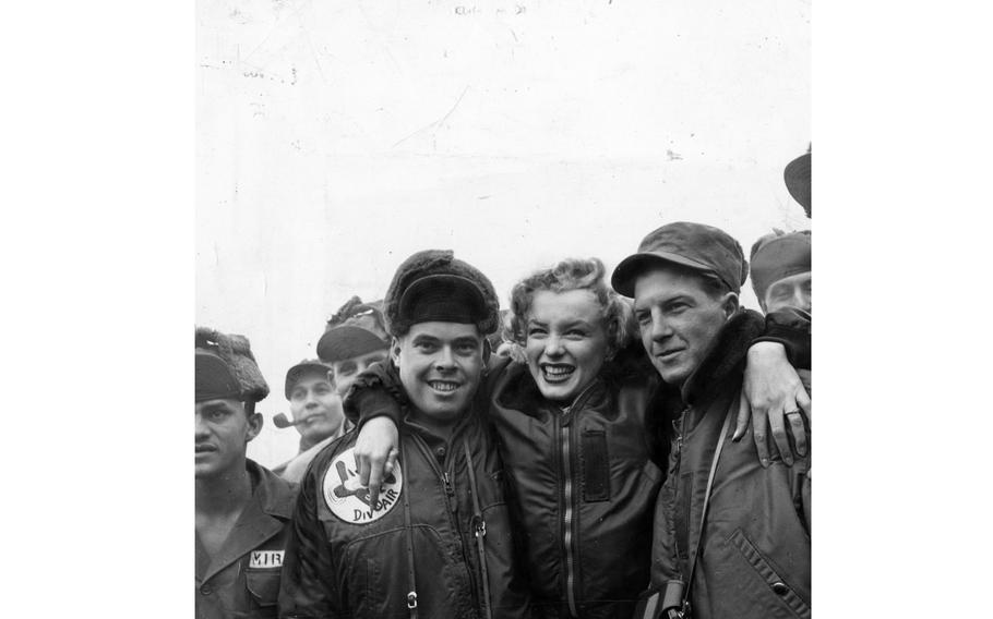 Marilyn Monroe poses with service members in South Korea