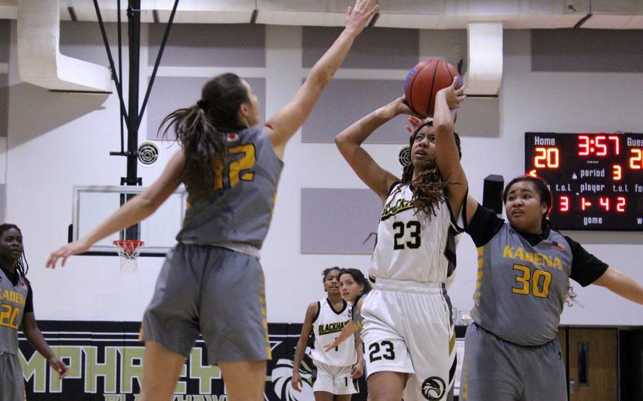 Humphreys' Jaelynn Leverette shoots against Kadena's Katelyn Wetherington. The Blackhawks won 35-31.