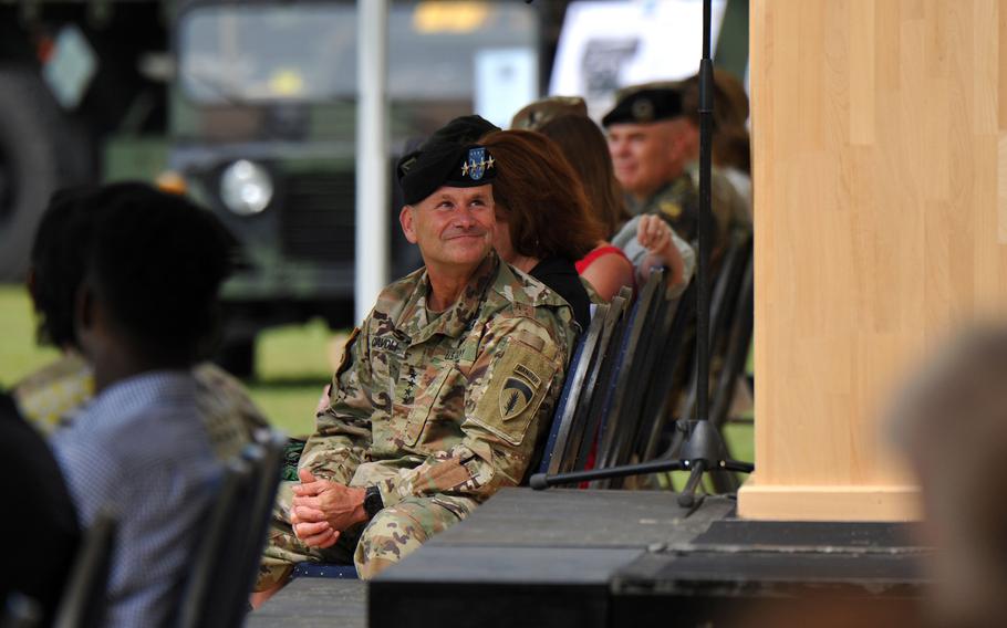 U.S. Army Europe and Africa commander Gen. Christopher Cavoli listens to the outgoing commander of the 21st Theater Sustainment Command, Maj. Gen. Christopher Mohan, give his farewell speech after turning over command of the 21st TSC to Brig. Gen. James Smith at Daenner Kaserne, Kaiserslautern, Germany, June 8, 2021. 