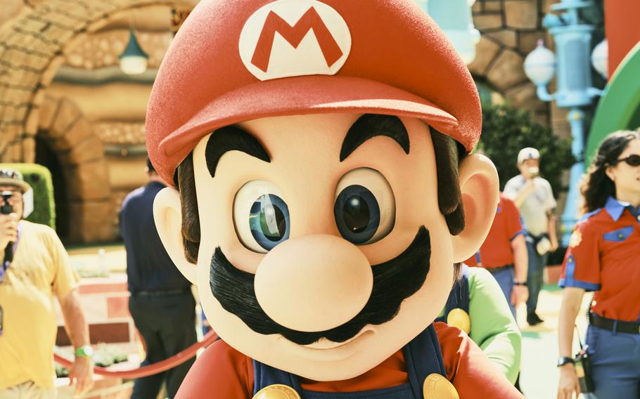 Actors in Mario and Luigi costumes interact with park guests at Super Nintendo World two days before the public opening of Epic Universe. 
