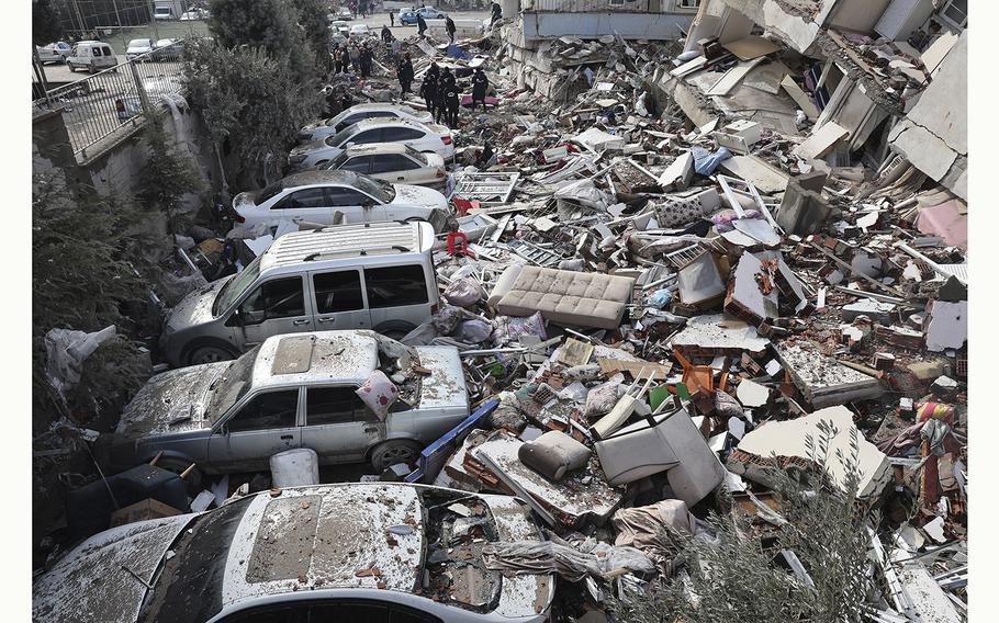 Vehicles are crushed under the rubble of collapsed buildings in Kahramanmaras, Turkey, on Feb. 7, 2023, the day after an earthquake struck the country’s southeast.
