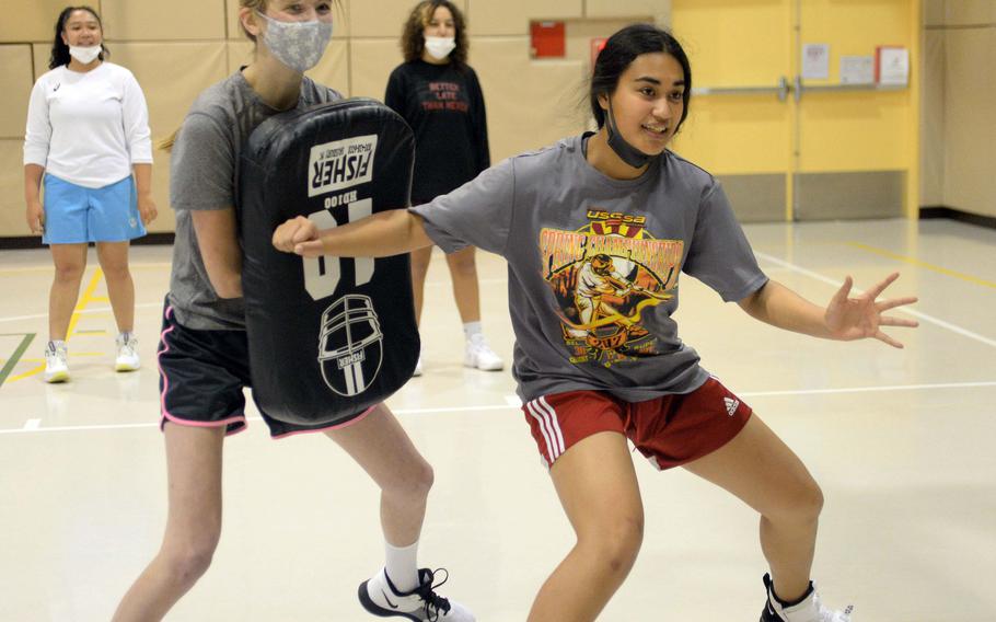 Zama senior Kiersten Sharp and sophomore Kiersten Aumua go through a post-positioning drill.