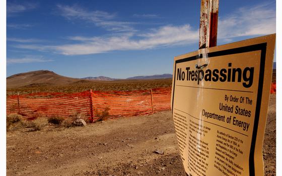 A "no trespassing" sign warns people to stay away from the proposed nuclear waste dump site of Yucca Mountain (L) Feb. 7, 2002, at Nellis Air Force Base, located approximately 90 miles north of Las Vegas, NV. In January, the U.S. Department of Energy endorsed a plan to transport vast amounts of radioactive waste from nuclear power plants across the nation for burial under Yucca Mountain, where it will take 10,000 years to decay. U.S. President George W. Bush could announce his support for the plan, which is opposed by many in Nevada, as early as this week. (David McNew/Getty Images/TNS)