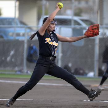 Kadena's Julia Petruff kicks and delivers against Kubasaki during Tuesday's Okinawa softball game. The Panthers won 19-4.