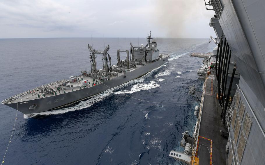 The Japan Maritime Self-Defense Force replenishment ship JS Hamana sails alongside the amphibious assault ship USS America during a replenishment-at-sea in the Pacific Ocean, May 22, 2021.