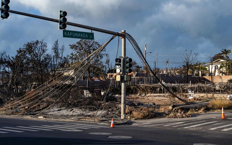 Fallen communications and power lines after the wildfire tore through Kapunakea Street and Honoapiilani Highway in Lahaina, Hawaii, on Aug. 10, 2023. 