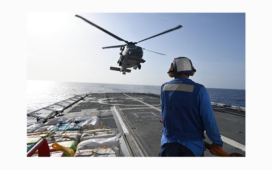 A helicopter from the USS Leyte Gulf (CG 55) hovers over the U.S. Coast Guard Cutter Mohawk (WMEC 913) in the Atlantic Ocean, April 24, 2024. 