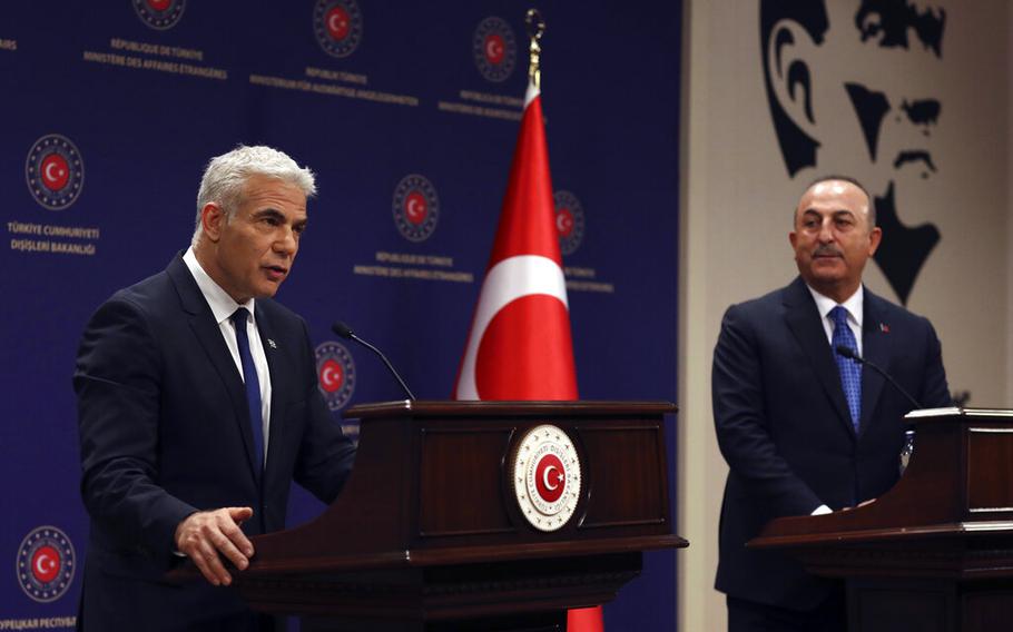 Israeli Foreign Minister Yair Lapid speaks during a briefing in Ankara, Turkey, on Thursday, June 23, 2022, as Turkish Foreign Minister Mevlut Cavusoglu looks on.