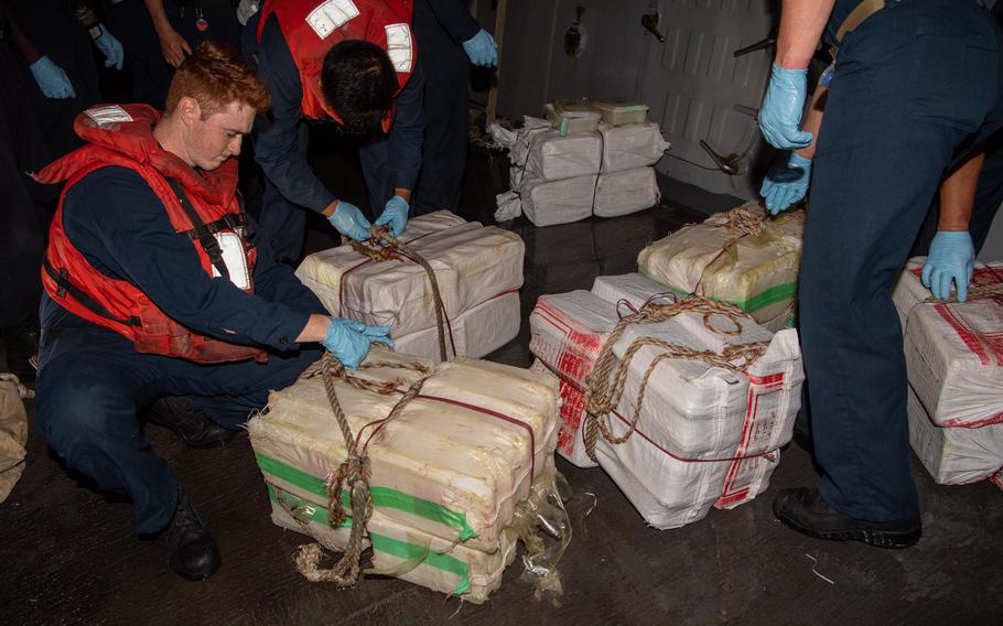 Sailors aboard the destroyer USS Momsen account for bags of illegal narcotics May 16, 2022. The drugs were seized from a fishing vessel in the Gulf of Oman. 