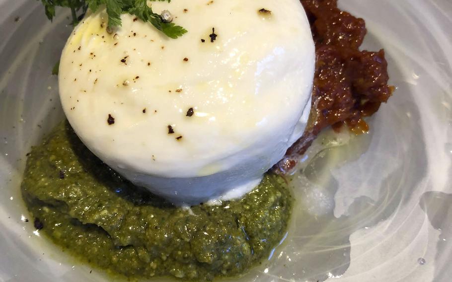 Sekai ichi tomato from We Are The Farm in Tokyo consists of half a sun-dried tomato with melted cream cheese on top and basil and kale pesto drizzled on the sides. 