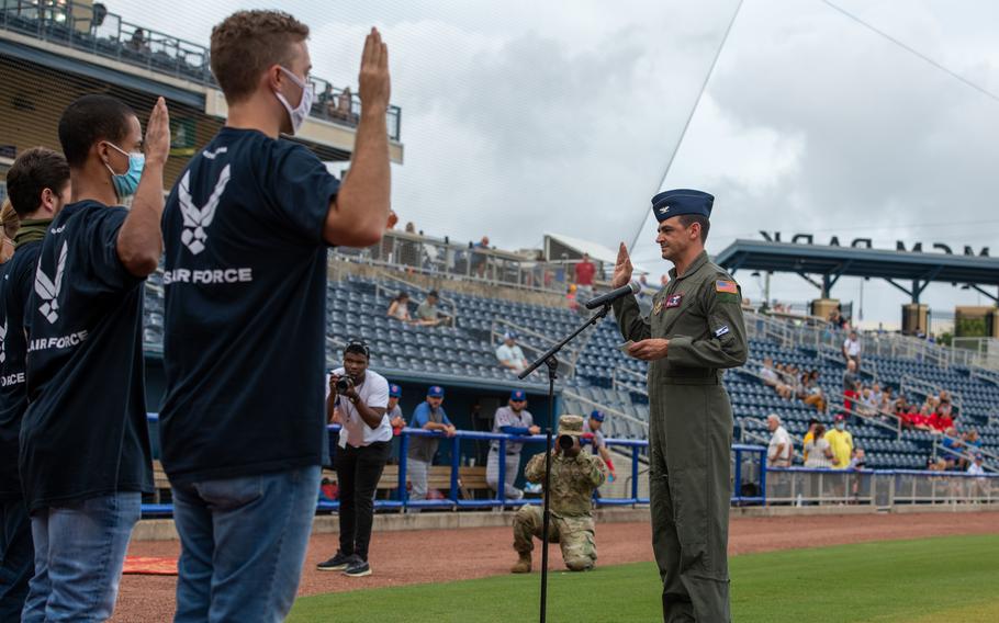 Air Force Col. Stuart M. Rubio, 403rd Wing commander, performs an oath of enlistment ceremony for new trainees during the Biloxi Shuckers Military Appreciation Night in Mississippi on Sept. 18, 2021. 