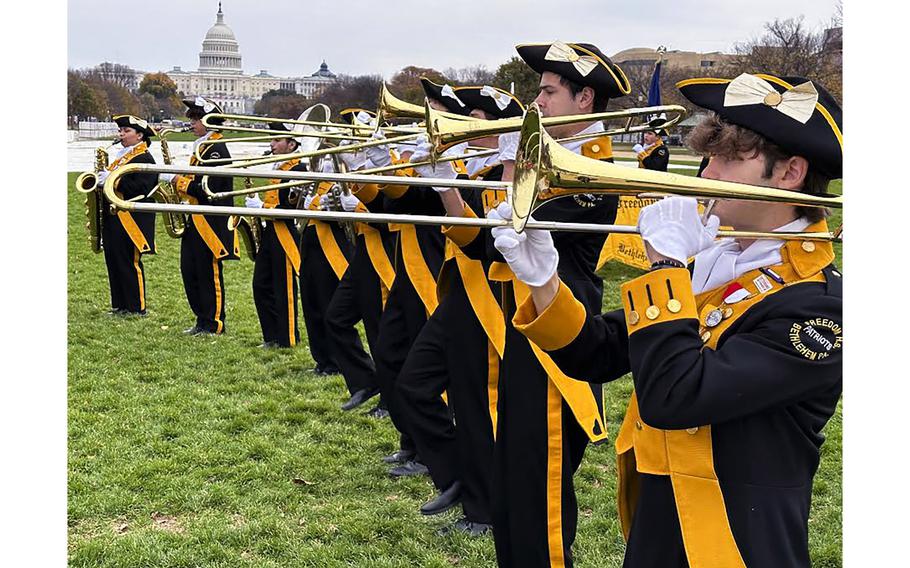 The Freedom High School Patriots marching band from Bethlehem, Pa., warms up on the National Mall before the National Veterans Day Parade on Sunday, Nov. 12, 2023, in Washington. 