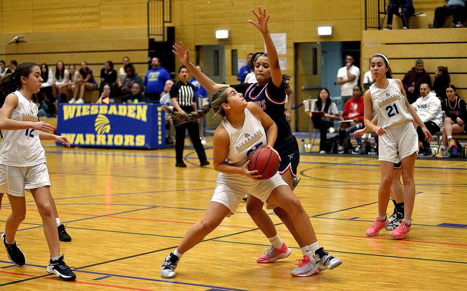 Wiesbaden's Natalie Bergdorf backs down Lakenheath's A'Lydia McNeal during a Dec. 1, 2023, game at Wiesbaden High School in Wiesbaden, Germany.