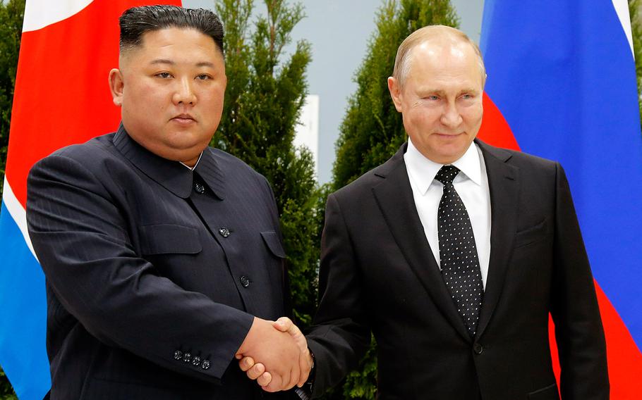 Russian President Vladimir Putin, right, and North Korea's leader Kim Jong Un shake hands during their meeting in Vladivostok, Russia.