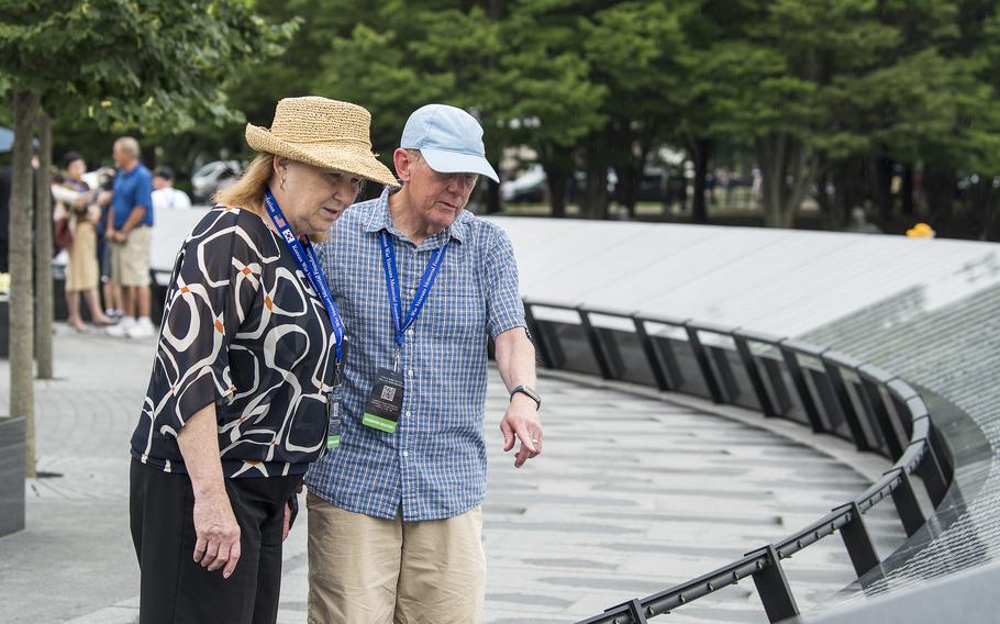 Vietnam veteran Terry Ogle and his wife Anne McEnerny-Ogle search names on the new Wall of Remembrance at the Korean War Memorial in Washington, D.C., on Tuesday, July 26, 2022.