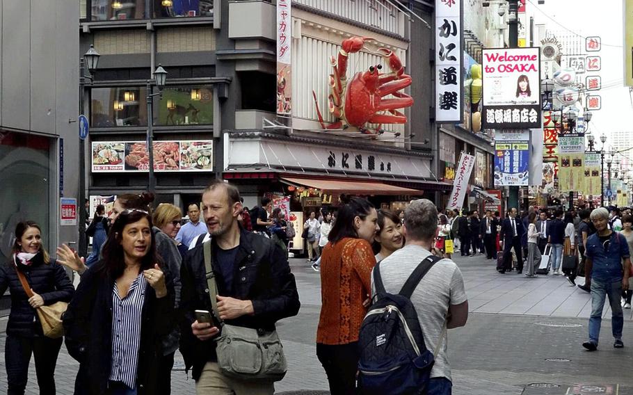 Foreign tourists are seen in the bustling Minami area of Osaka City in October 2018.