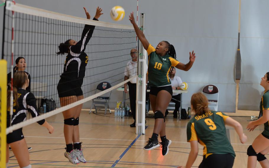 Nyla Williamson of SHAPE, right, sends the ball over the net as Stuttgart Panthers’ Isciss Perez goes for the block Thursday, Oct. 27, 2022, at Ramstein Air Base, Germany.