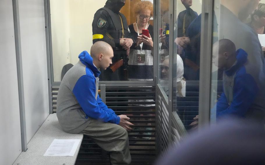 Russian army Sgt. Vadim Shishimarin, 21, is seen behind a glass during a court hearing in Kyiv, Ukraine, Friday, May 13, 2022.