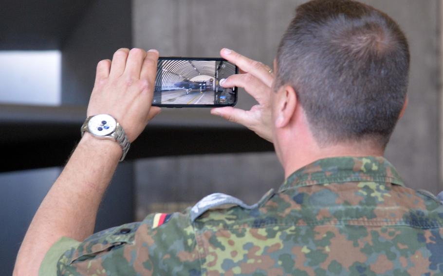 A German service member takes a photo of an F-35 Lightning II in a hangar at Spangdahlem Air Base, Germany, on June 14, 2023. The country is set to buy F-35s, so a number of maintainers got a look at the multirole combat aircraft.