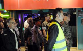 Okinawa Gov. Denny Tamaki, far left, joins a U.S.-Japan patrol of Gate 2 Street in Okinawa city, Okinawa, April 18, 2025. 