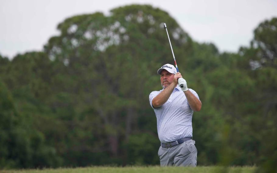 A man swings a golf club 