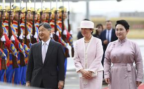 Japanese Emperor Naruhito, left, and Empress Masako, walk with Mongolian Foreign Minister Batmunkh Battsetseg, right, after arriving at the Chinggis Khaan International Airport near Ulaanbaatar, Mongolia on Sunday, July 6, 2025. (MONTSAME News Agency via AP)