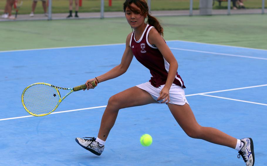 Matthew C. Perry’s Nina Altig chases down the ball during Friday’s tennis matches against Zama. Altig won her doubles and mixed doubles matches.