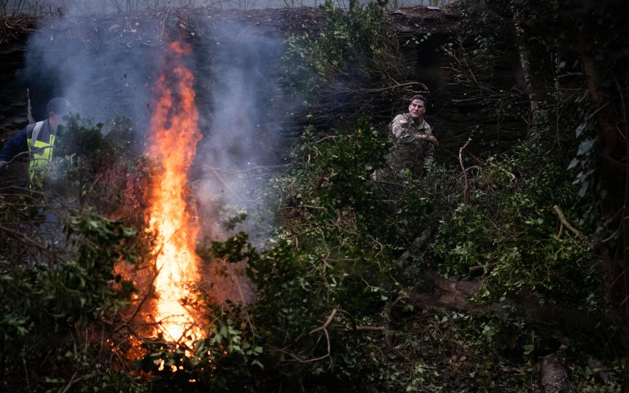 Col. Matthew Alexander throws undergrowth on a bonfire in St. Goar, Germany, on Feb. 23, 2023.