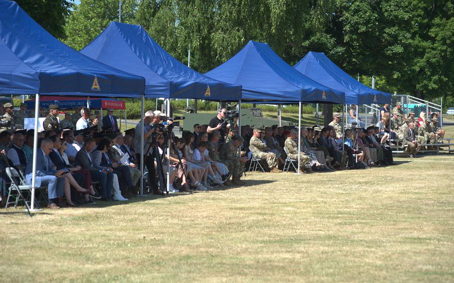 The crowd gathers under blue tents.