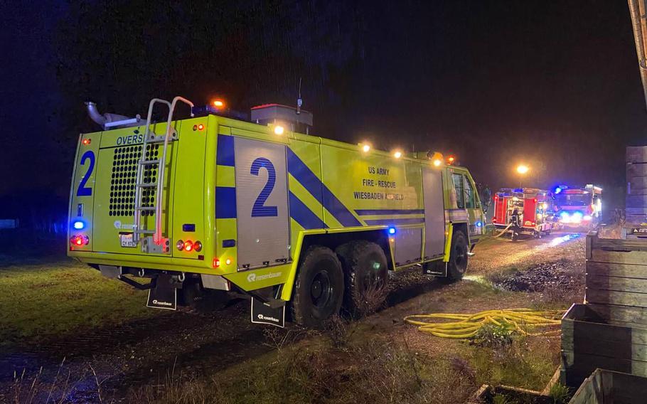 A U.S. Army firetruck at the scene of a fire in Delkenheim, Germany, early Tuesday, Dec. 28, 2021. About 2,750 cubic yards of dung at an agricultural facility caught on fire. A police spokesman said the manure pile’s own heat likely was the cause.