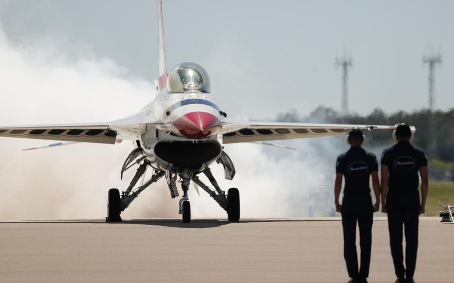 Crew members stand at attention as the United States Thunderbirds prepare to perform.