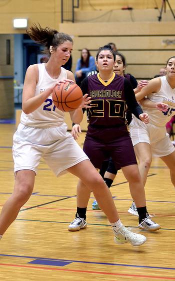 Wiesbaden's Lyndsey Urick, left, backs down Baumholder's Alex Barreto, center, during Friday's game at Wiesbaden High School in Wiesbaden, Germany.