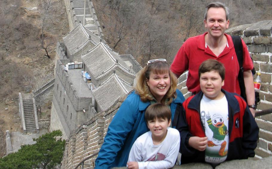 Andrew and Cathy Hakun pose with their and sons Steven, right, and Patrick during a visit to the Great Wall of China in April 2013.