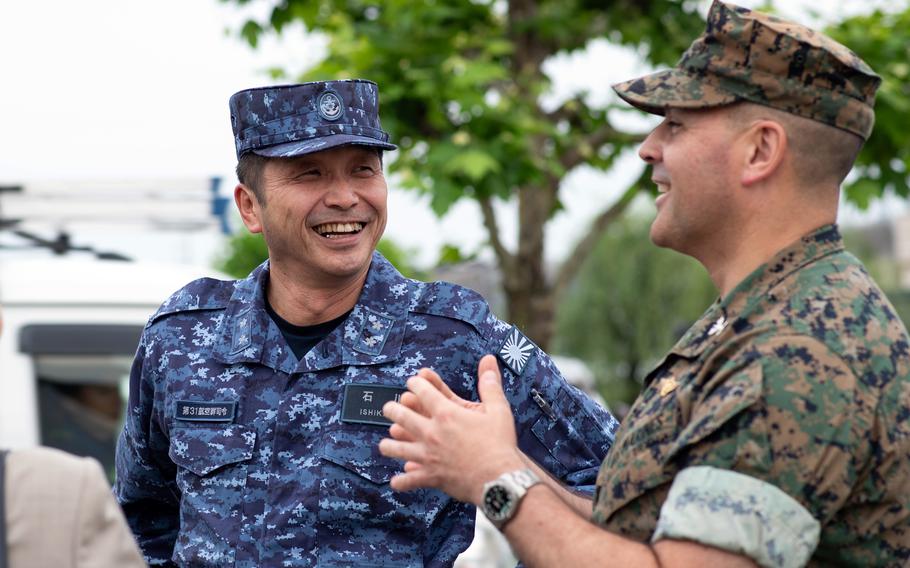 A colonel and a rear admiral talk ahead of a ceremony.