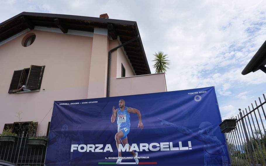 A poster reading "Go Marcell" for Italy's Lamont Marcell Jacobs, the gold medalist in the 100 meters at the Tokyo Olympics, is seen in front of the hotel Florence, run by his mother Viviana Masini in Manerba del Garda, Italy, Monday, Aug. 2, 2021.