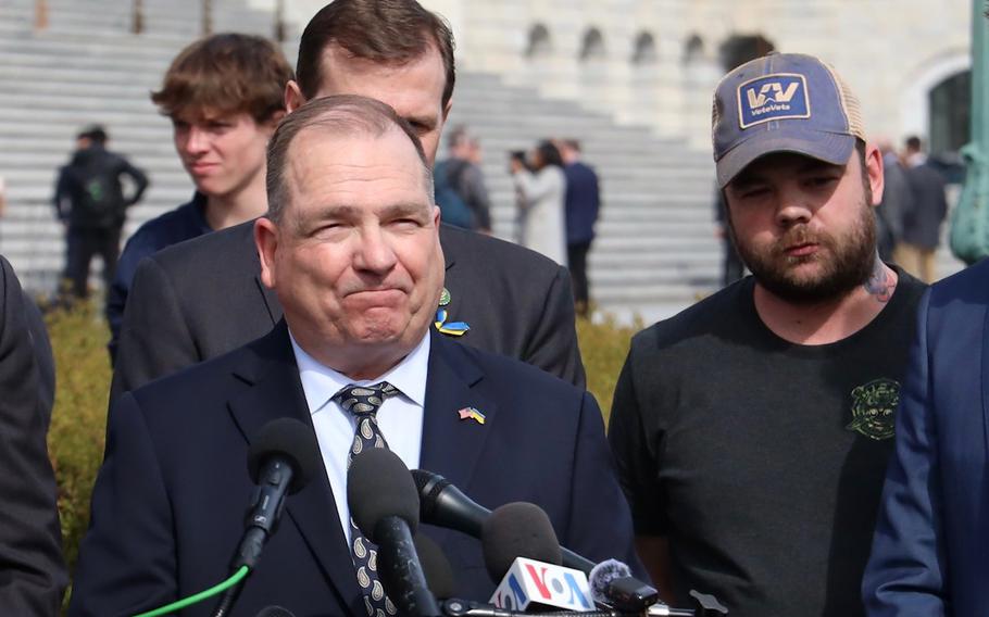 Richard Harris, left, speaks at a rally Wednesday, March 13, 2024, on Capitol Hill. Listening at right is veteran Ryan O’Leary.