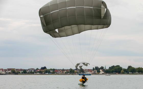A U.S. Army paratrooper from the 173rd Brigade Support Battalion, 173rd Airborne Brigade, hits the water during a jump onto Lake Constance, Germany, Friday, July 29, 2022. More than 70 paratroopers from the brigade participated along with 75 German paratroopers from the 26th (Saarland) Airborne Brigade.