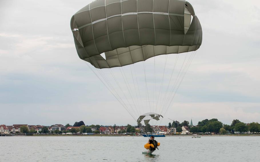 A U.S. Army paratrooper from the 173rd Brigade Support Battalion, 173rd Airborne Brigade, hits the water during a jump onto Lake Constance, Germany, Friday, July 29, 2022. About paratroopers from the brigade participated along with 75 German paratroopers from the 26th (Saarland) Airborne Brigade.