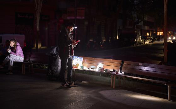 A man sells battery-powered radios and torches on a Barcelona street during the blackout in Barcelona, Spain, Tuesday, April 29, 2025. (AP Photo/Emilio Morenatti)