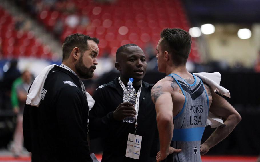 Army Staff Sgt. Spenser Mango, center, is a wrestling coach for Team USA at the Olympic Games in Tokyo. 